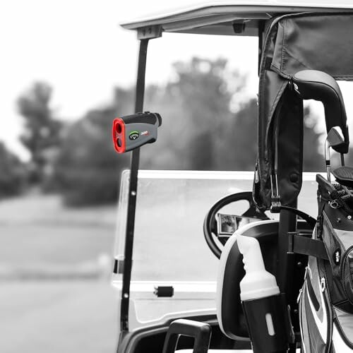 Golf cart with a mounted rangefinder and golf bag.